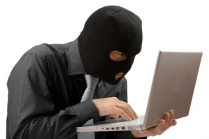 A Black-masked Hacker Breaking into a Computer