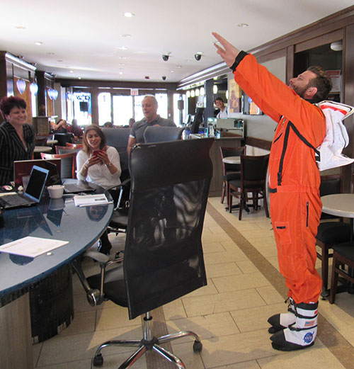 BitNATIONAL owner Jeff shows how bitcoin will take off but wearing an orange Nasa suit.