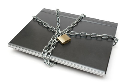 Photo of a laptop with chain and padlock symbolizing laptop virus.